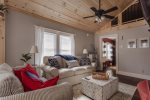 vaulted ceilings and cozy furnishings in the living area 